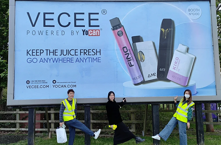 The VECEE team poses with a VECEE advertisement